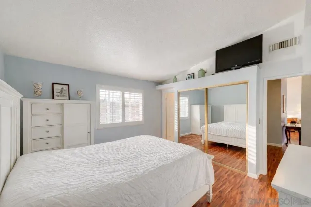 a front view of a house with a yard and a garden