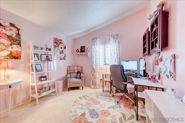 an aerial view of house with outdoor space and trees all around