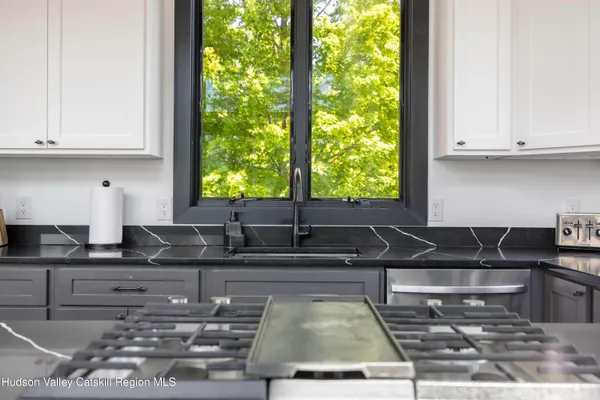a living room with furniture a flat screen tv and a kitchen view