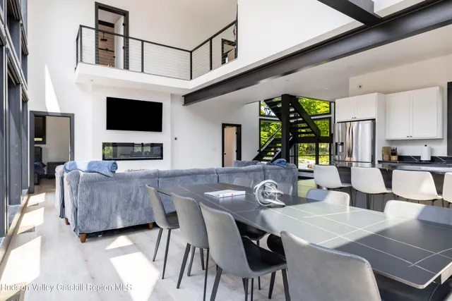 a bedroom with a bed and large windows