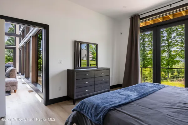 a bedroom with a bed and a dresser in it