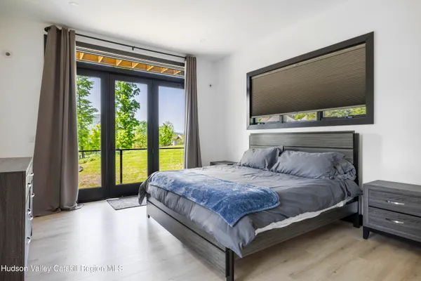 a bathroom with a bathtub a sink and a large mirror