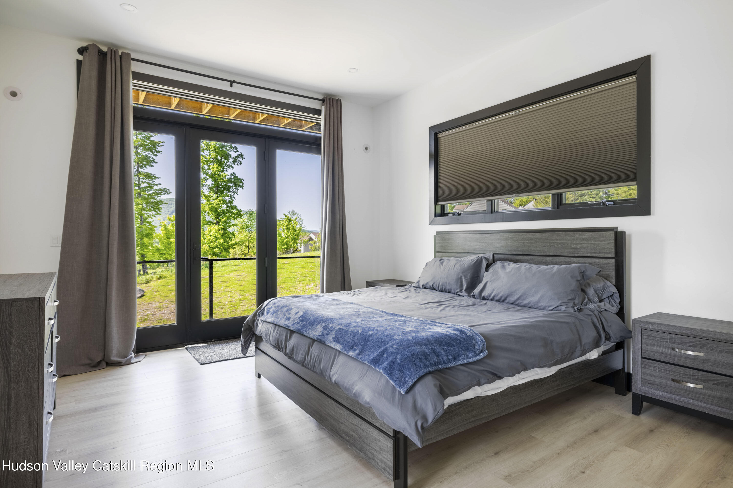 4 Goff Road Windham, NY 12496 - Photo 16 of 68 a bedroom with a large bed and a flat tv screen on dresser