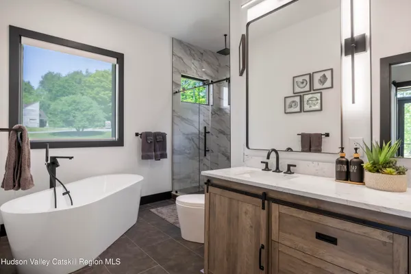 a bathroom with a toilet a sink and a window