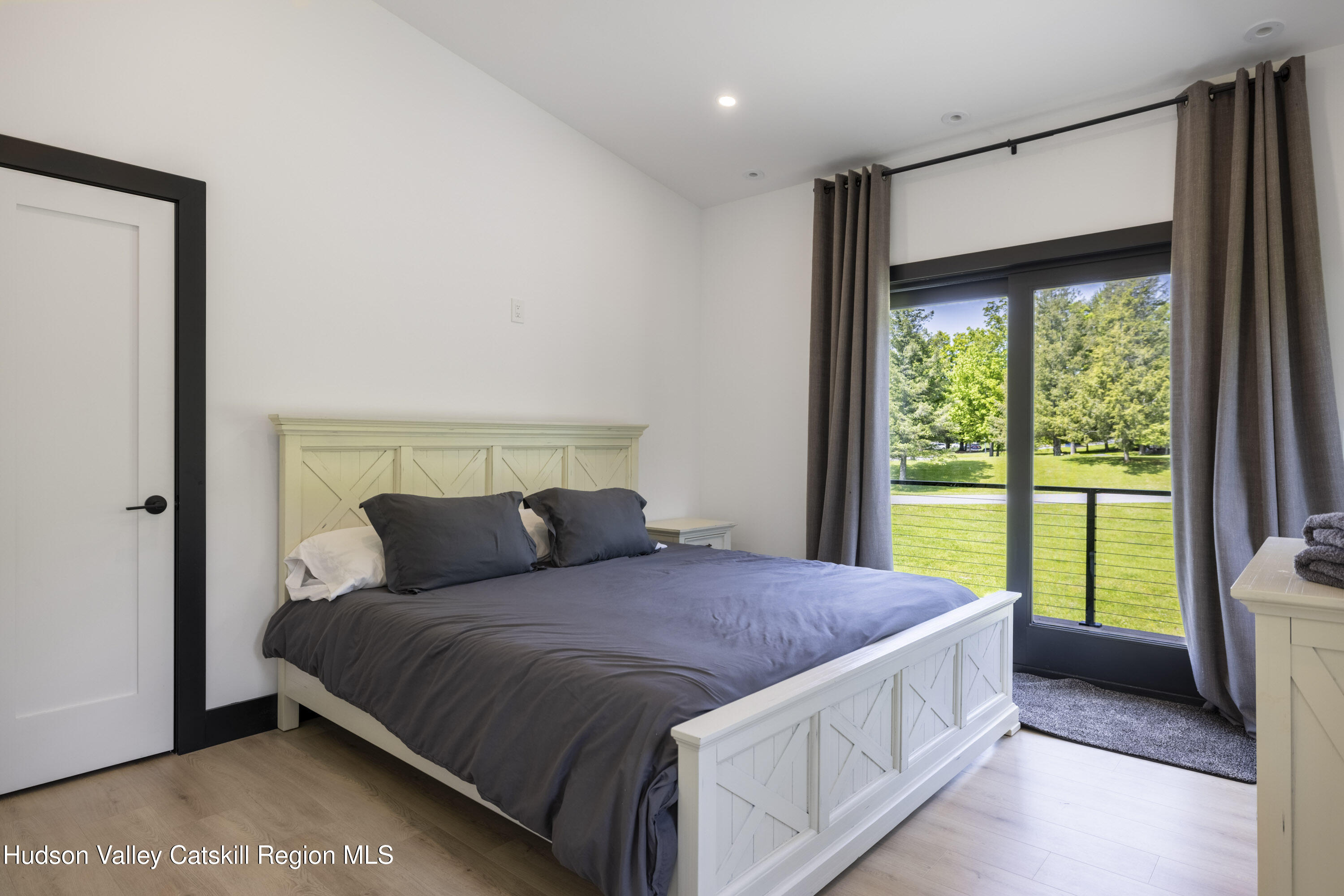 4 Goff Road Windham, NY 12496 - Photo 32 of 68 a bedroom with a large bed and a large window