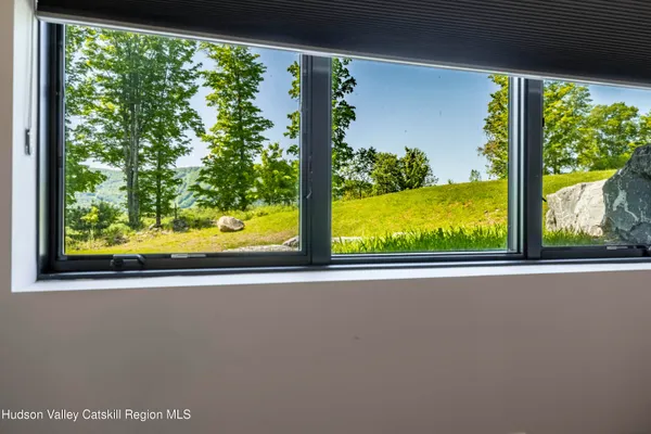 a view of balcony with floor to ceiling windows and wooden floor