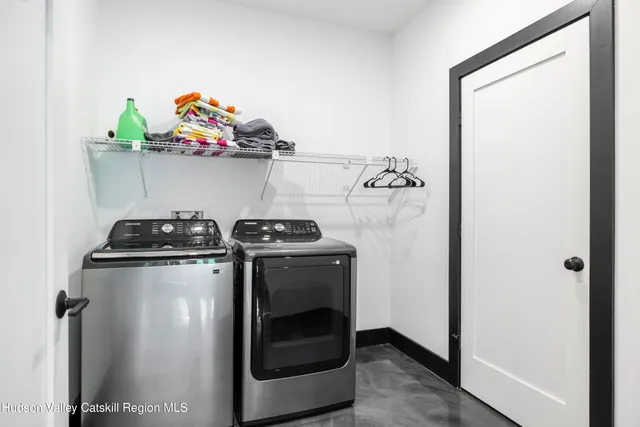 a green field with lots of trees in the background