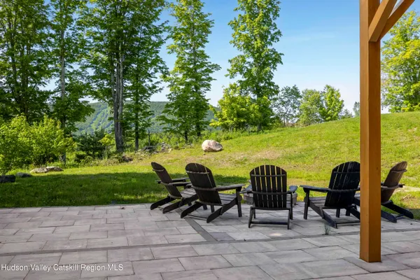 an aerial view of residential houses with outdoor space and trees