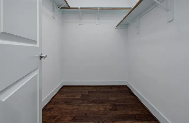 a view of a room with wooden floor