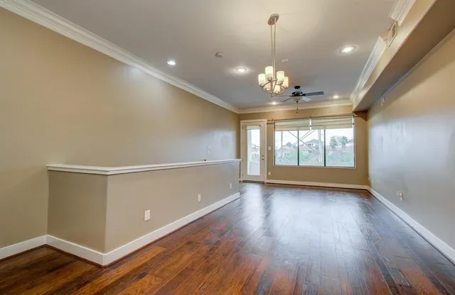 a view of a room with wooden floor and chandelier