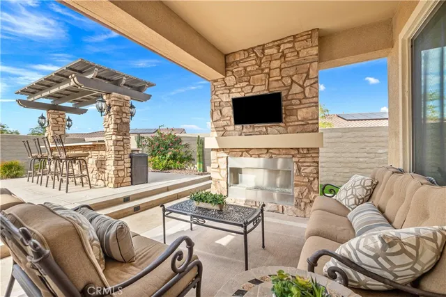 a view of a house with a yard patio and fire pit