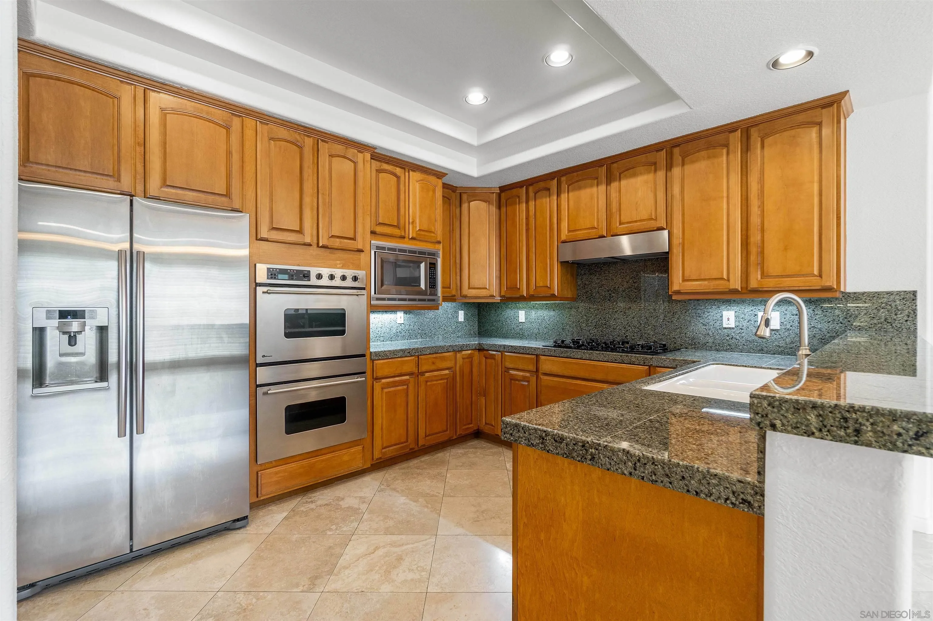 1355 Caminito Balada La Jolla, CA 92037 - Photo 13 of 31 a kitchen with stainless steel appliances granite countertop a sink a stove and a refrigerator