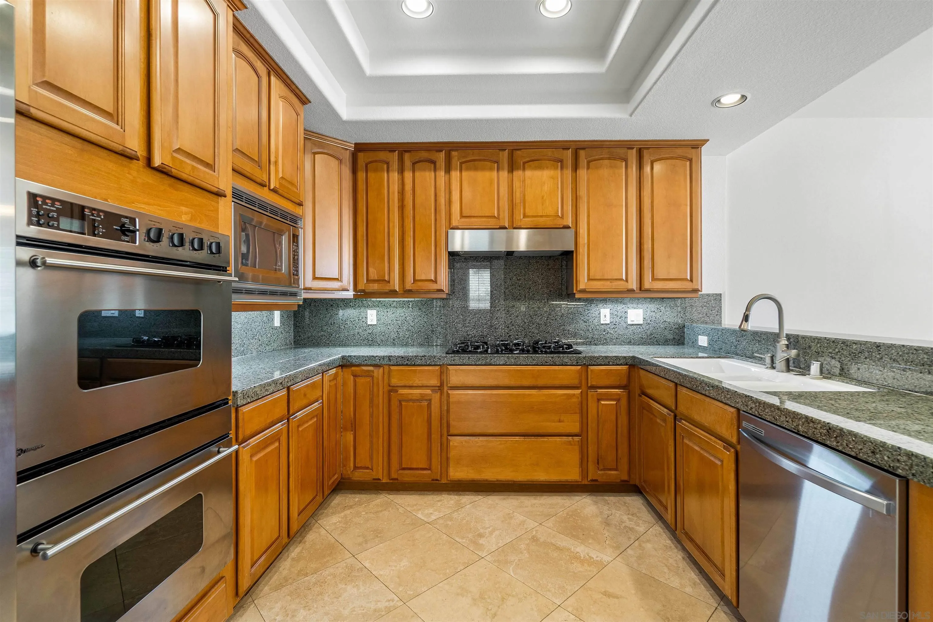 1355 Caminito Balada La Jolla, CA 92037 - Photo 14 of 31 a kitchen with stainless steel appliances granite countertop a sink stove and cabinets