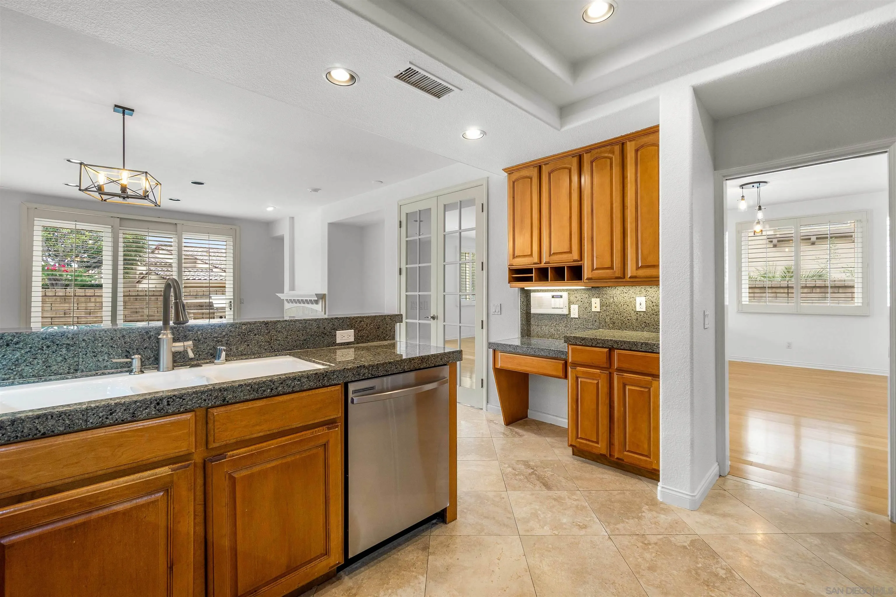 1355 Caminito Balada La Jolla, CA 92037 - Photo 16 of 31 a large kitchen with kitchen island granite countertop a sink and dishwasher with a large window