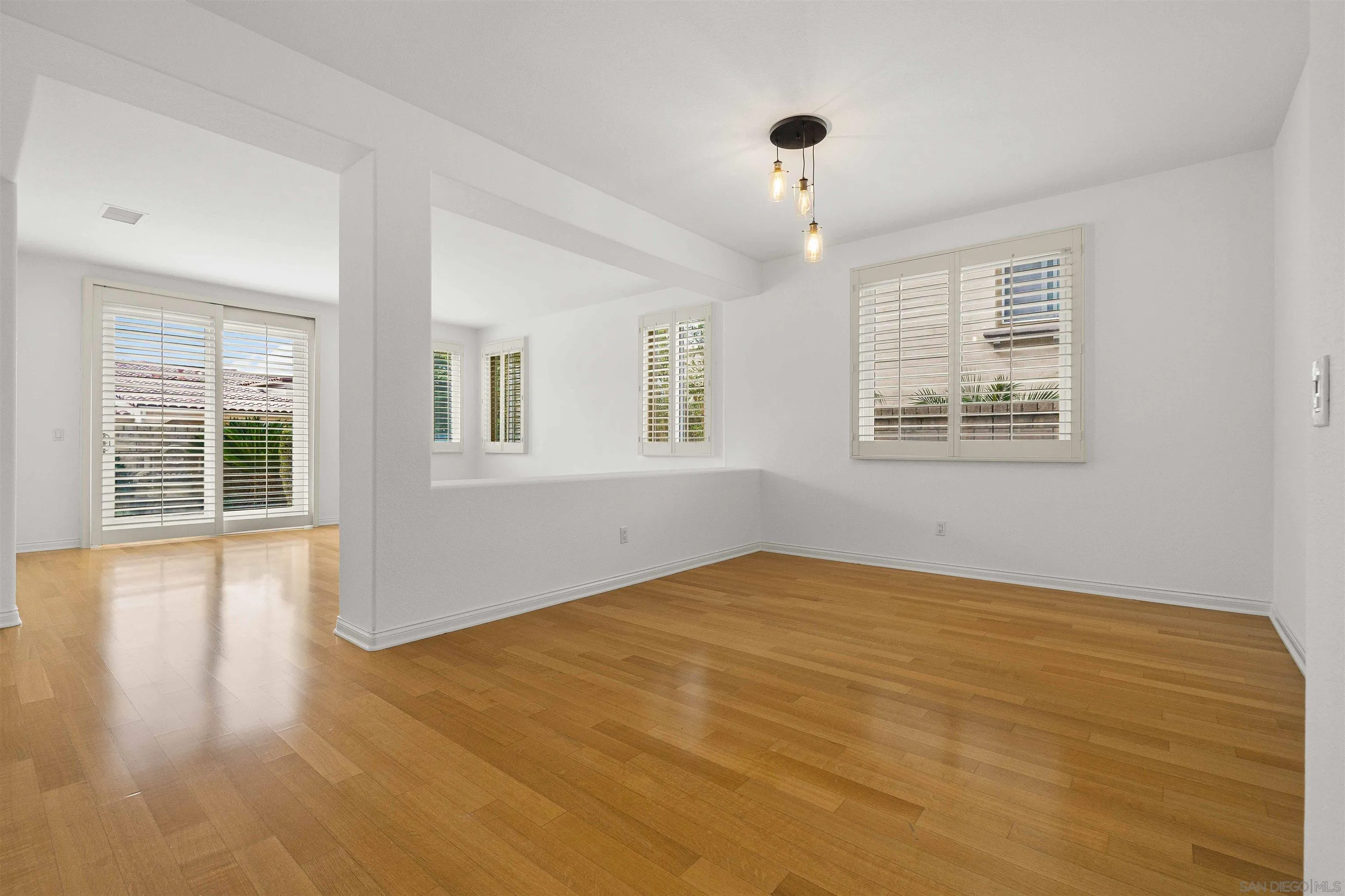 1355 Caminito Balada La Jolla, CA 92037 - Photo 6 of 31 a view of an empty room with a window and wooden floor
