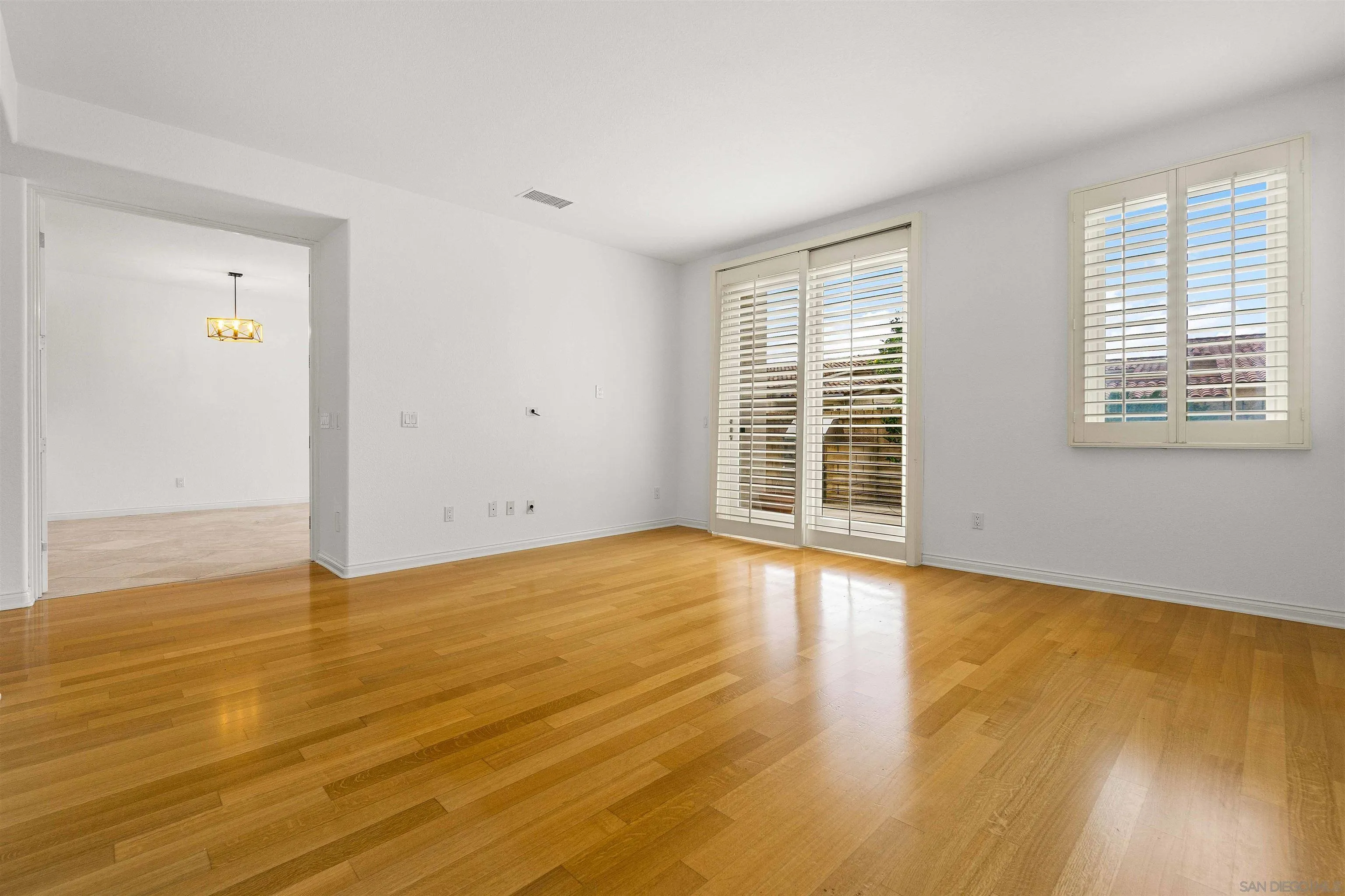 1355 Caminito Balada La Jolla, CA 92037 - Photo 10 of 31 a view of an empty room with wooden floor and a window