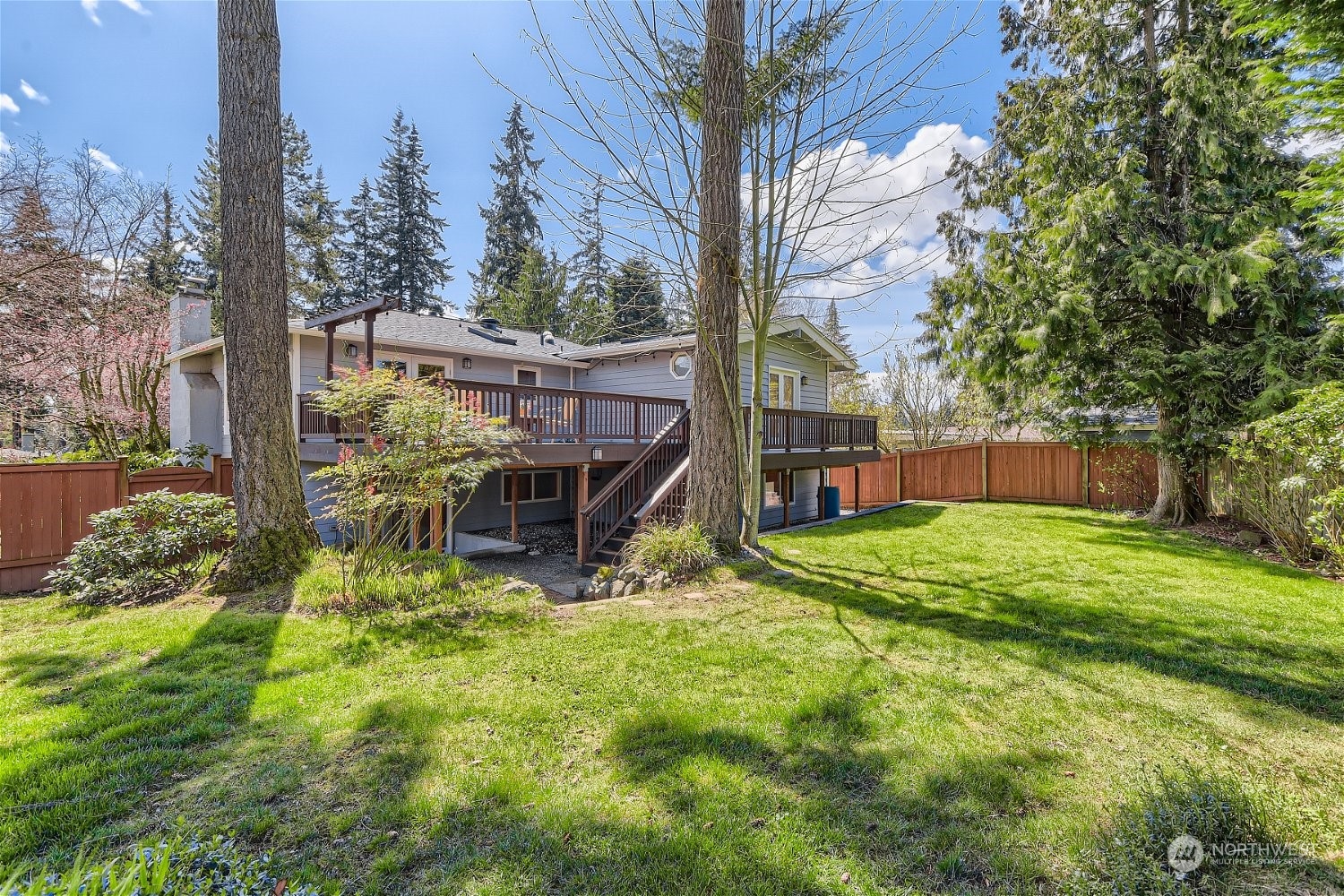 3 218th Place Southwest Bothell, WA 98021 - Photo 25 of 27 a view of backyard with a table and chairs and wooden fence