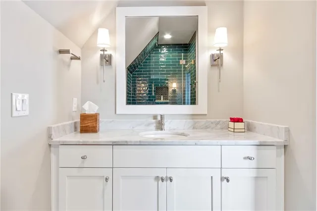 a bathroom with a sink and a mirror