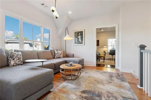 a living room with furniture a ceiling fan and a rug
