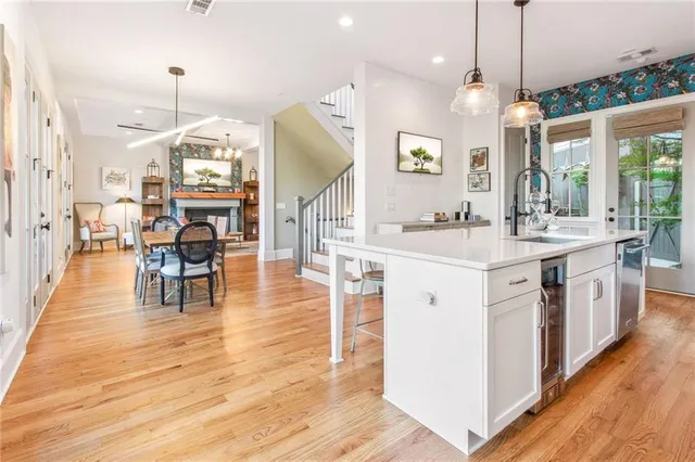 a kitchen with a sink stove and wooden floor