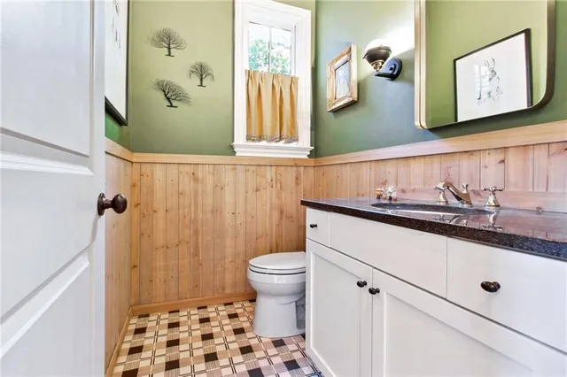 a bathroom with a sink a toilet and shower curtain