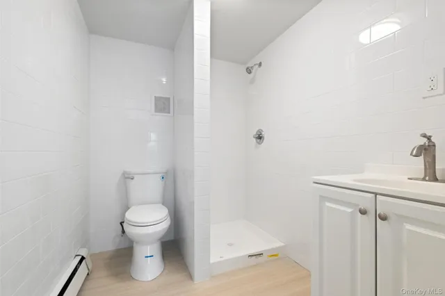 a white toilet sitting next to a bathroom sink