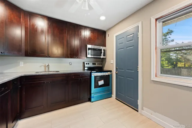 a kitchen with stainless steel appliances granite countertop a refrigerator and a sink