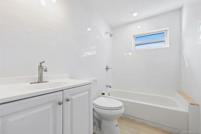 a bathroom with a toilet a sink and bathtub