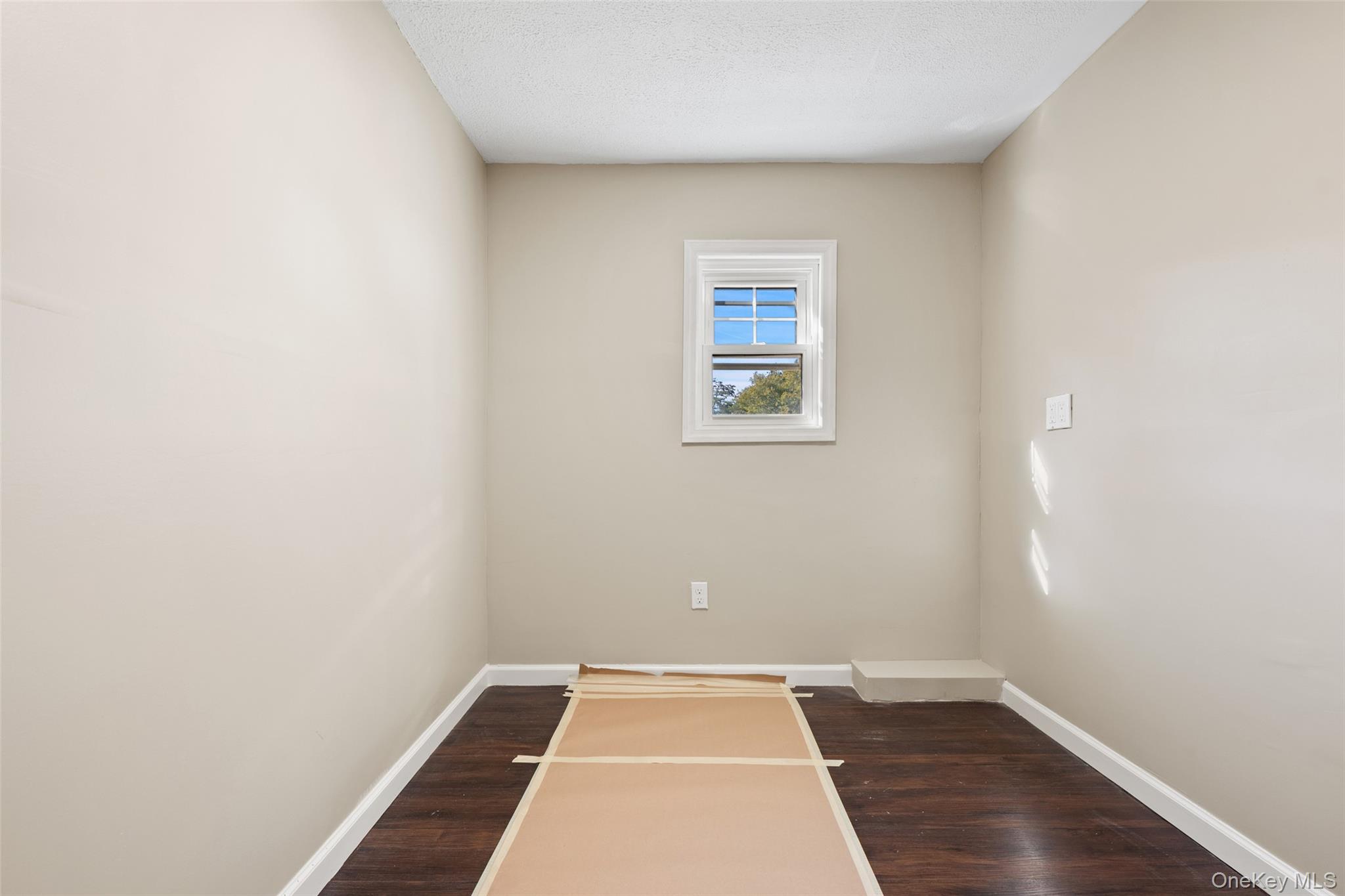 40 Duke Street Deer Park, NY 11729 - Photo 9 of 15 Spare room with dark wood-style floors and a textured ceiling