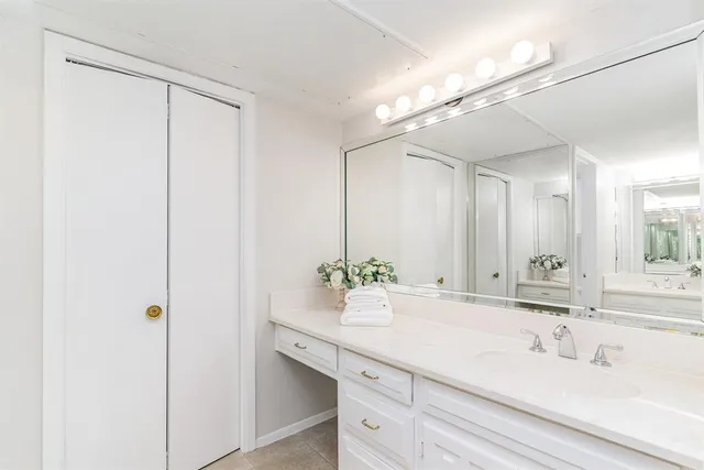 a bathroom with a double vanity sink and a mirror