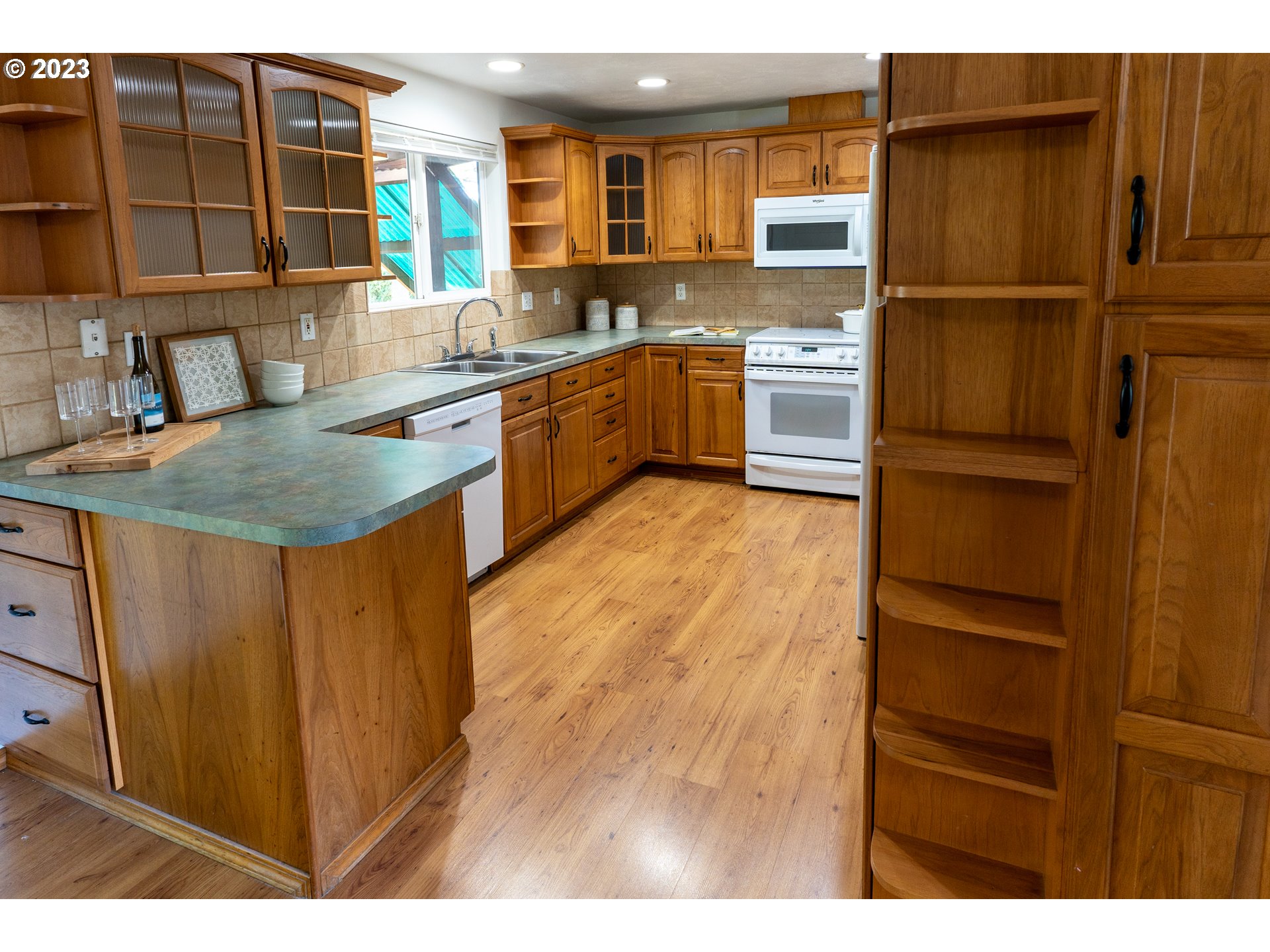 18760 Cook Street Oregon City, OR 97045 - Photo 11 of 36 a kitchen with kitchen island a counter top space cabinets and stainless steel appliances