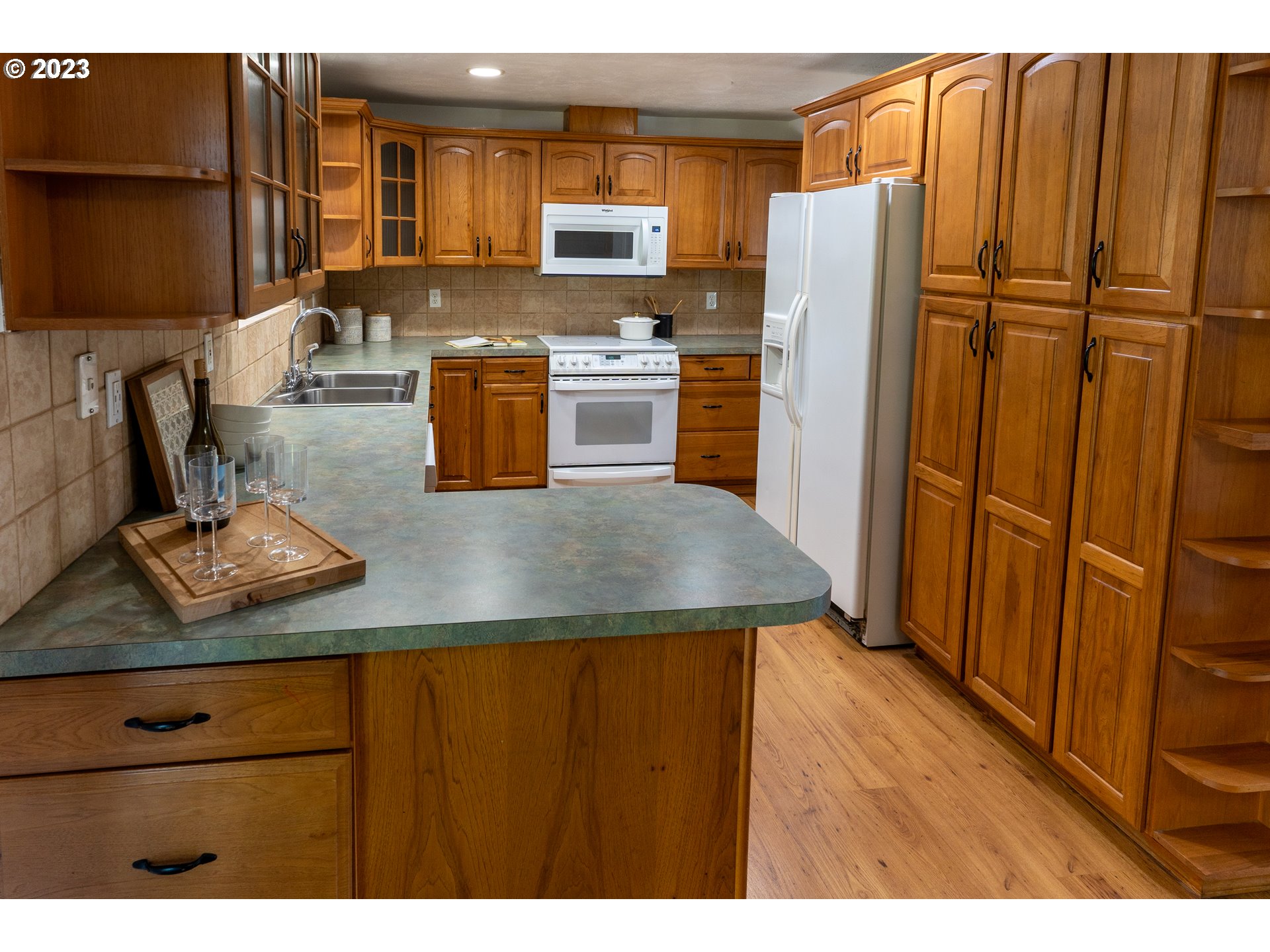 18760 Cook Street Oregon City, OR 97045 - Photo 12 of 36 a kitchen with a refrigerator and a stove top oven