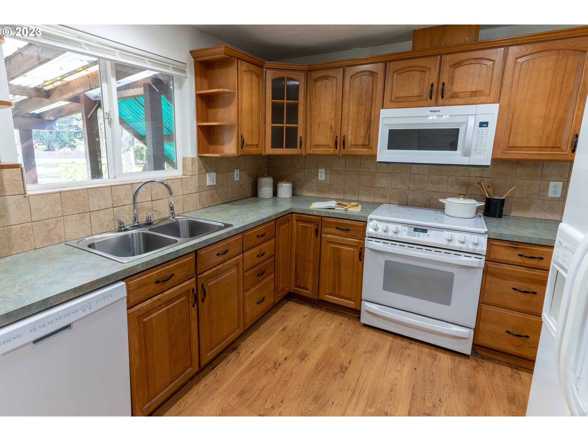 18760 Cook Street Oregon City, OR 97045 - Photo 13 of 36 a kitchen with stainless steel appliances granite countertop a sink stove and cabinets