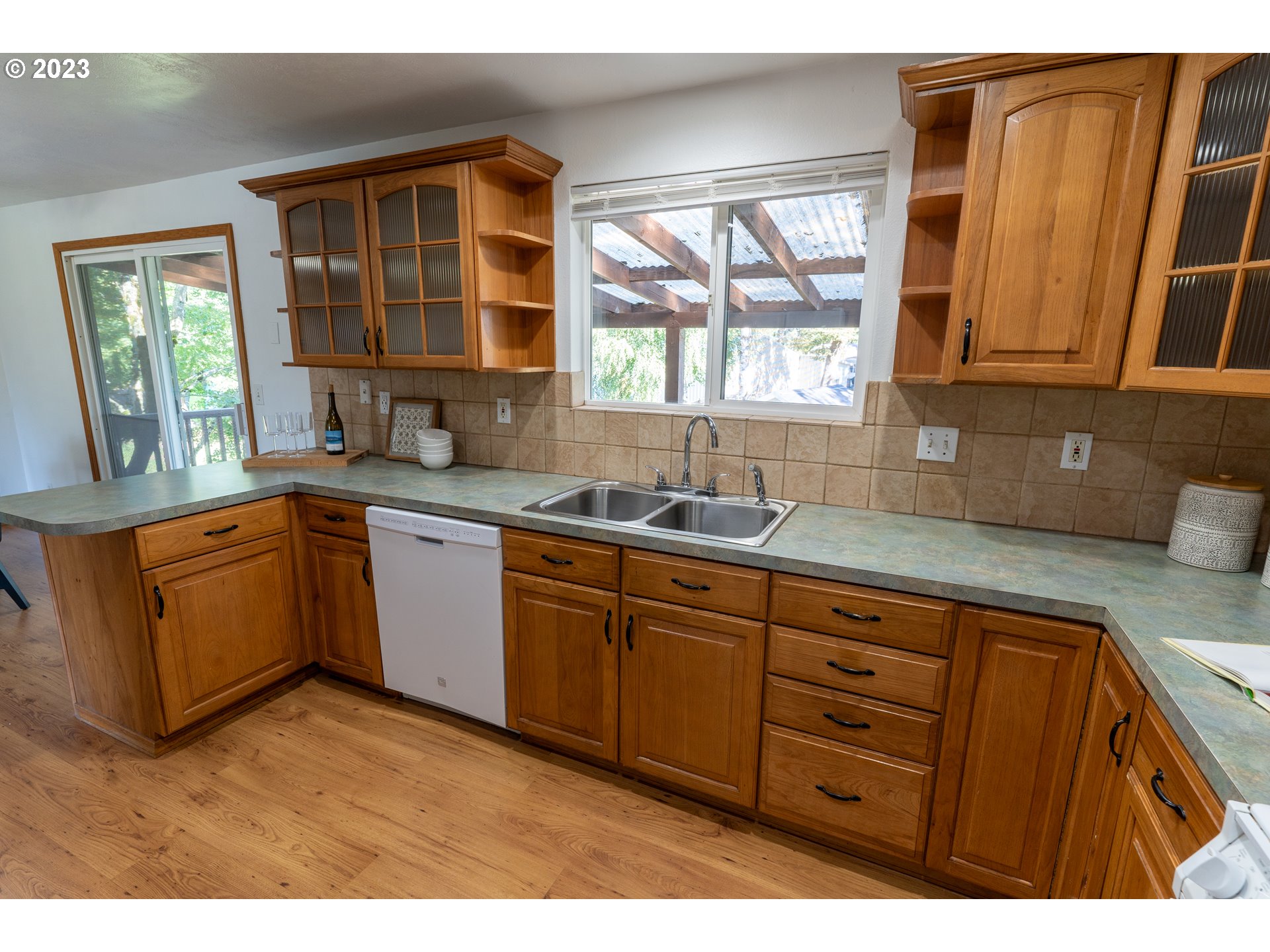 18760 Cook Street Oregon City, OR 97045 - Photo 14 of 36 a kitchen with sink window and cabinets