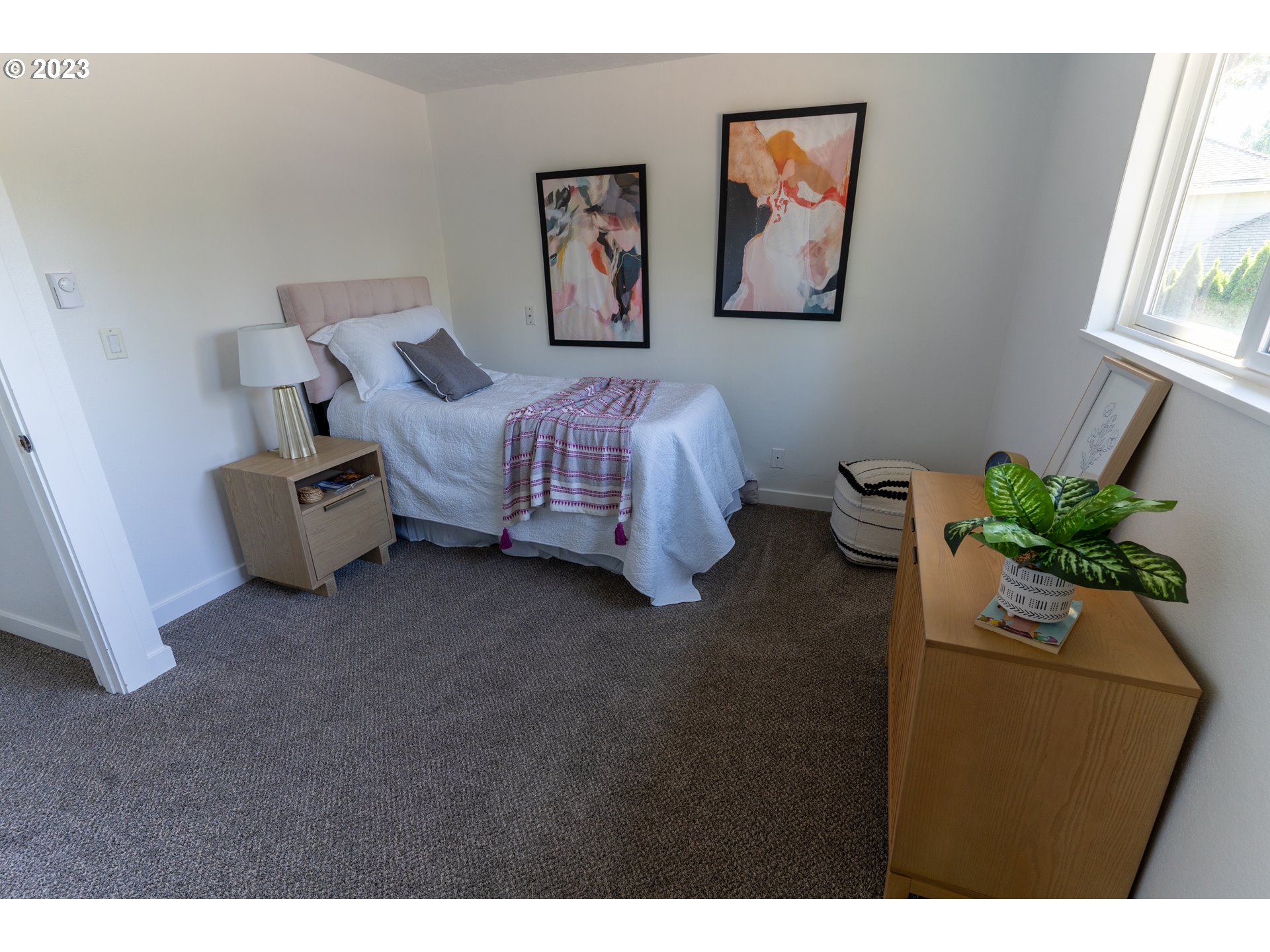 18760 Cook Street Oregon City, OR 97045 - Photo 16 of 36 a bed room with a bed and a painting on the wall