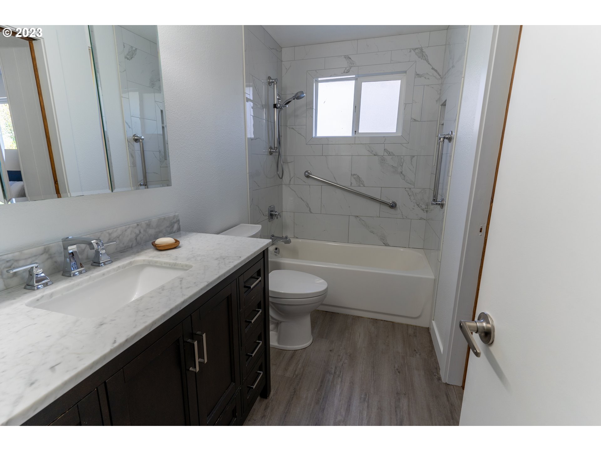 18760 Cook Street Oregon City, OR 97045 - Photo 19 of 36 a bathroom with a granite countertop sink toilet a mirror and shower
