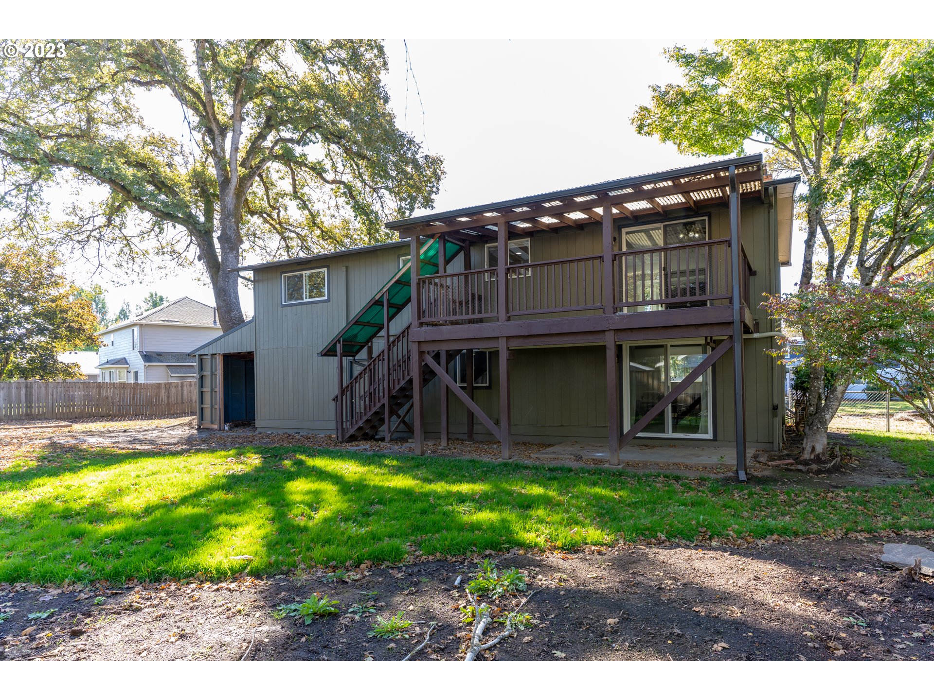 18760 Cook Street Oregon City, OR 97045 - Photo 34 of 36 a view of a house with a yard patio and a small yard
