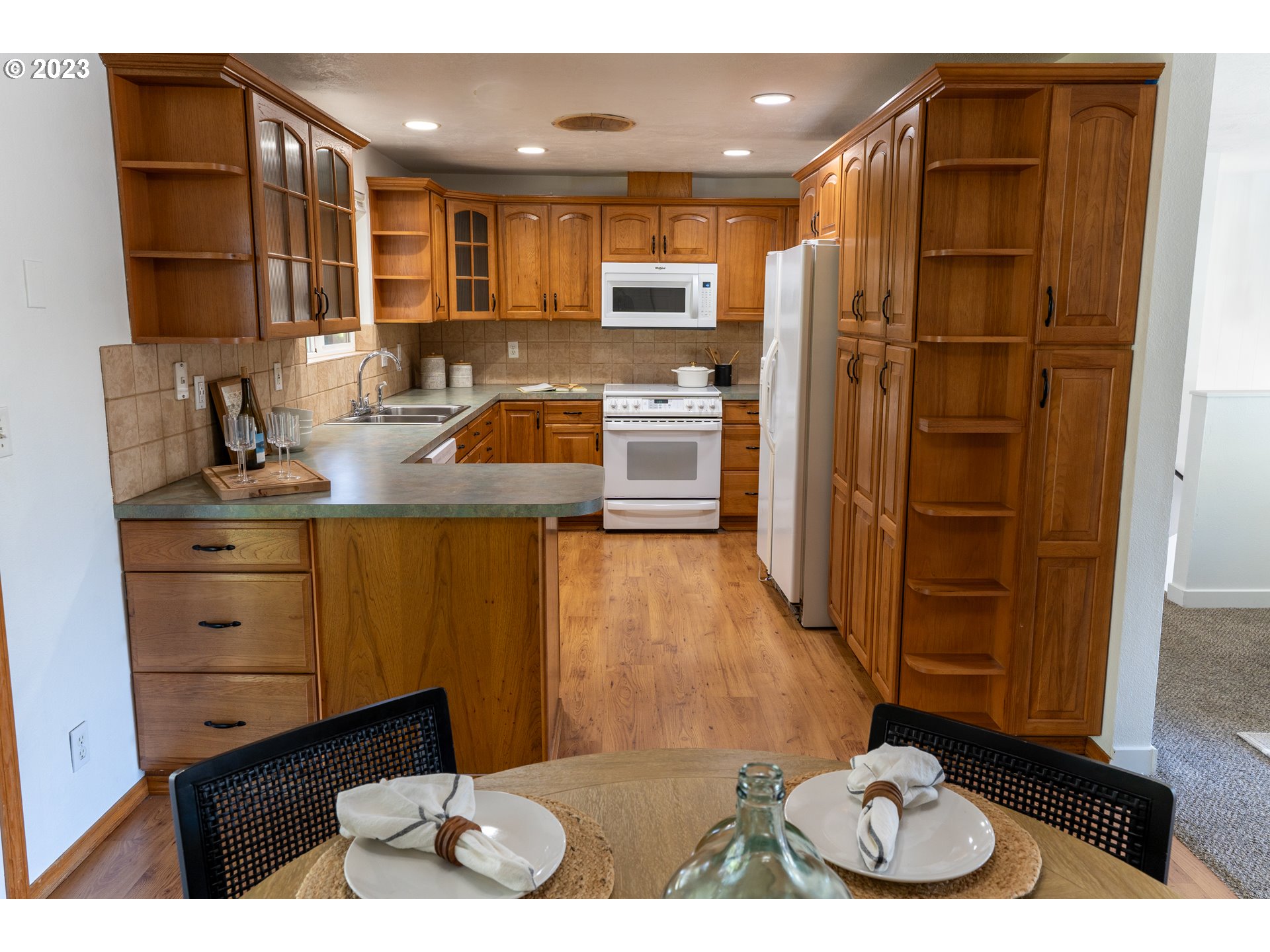 18760 Cook Street Oregon City, OR 97045 - Photo 10 of 36 a kitchen with kitchen island granite countertop a refrigerator and a sink