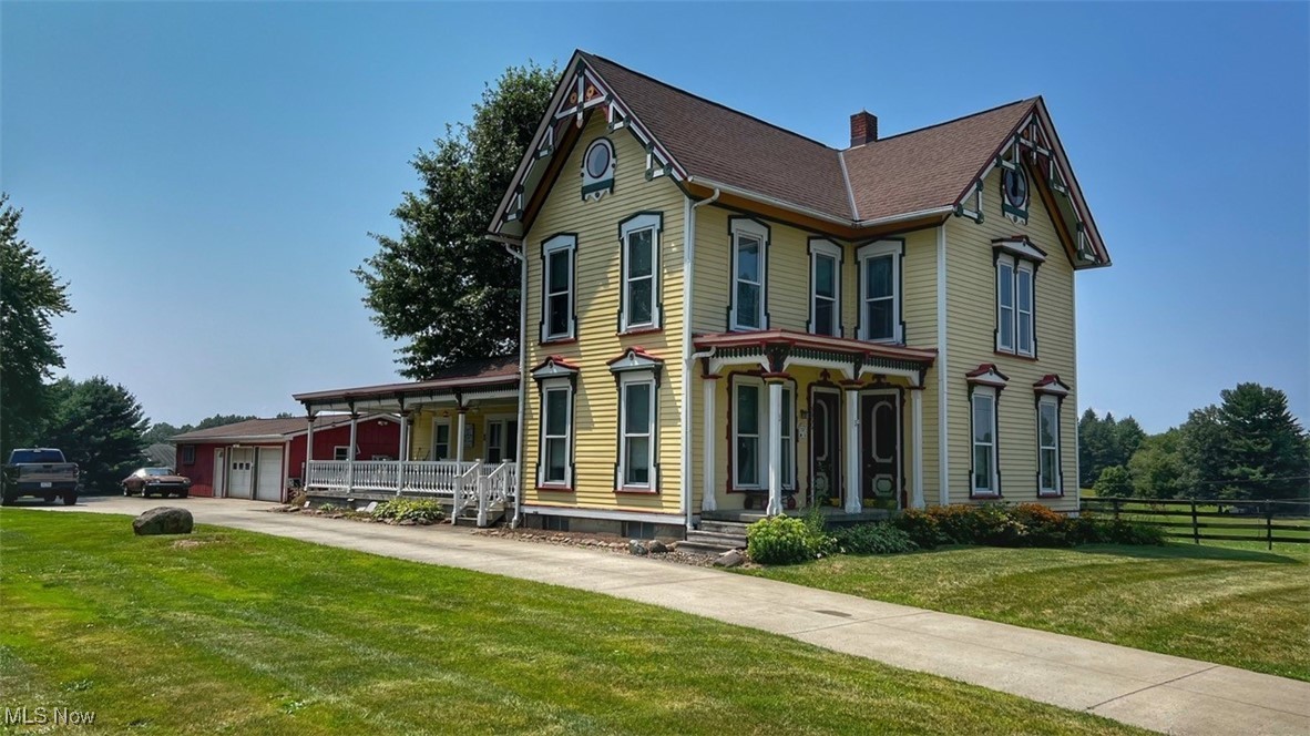 3956 Tallmadge Road Rootstown, OH 44272 - Photo 2 of 26 Victorian house with a front yard and covered porch