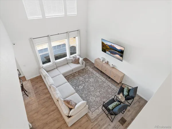 view of living room with furniture and floor to ceiling window