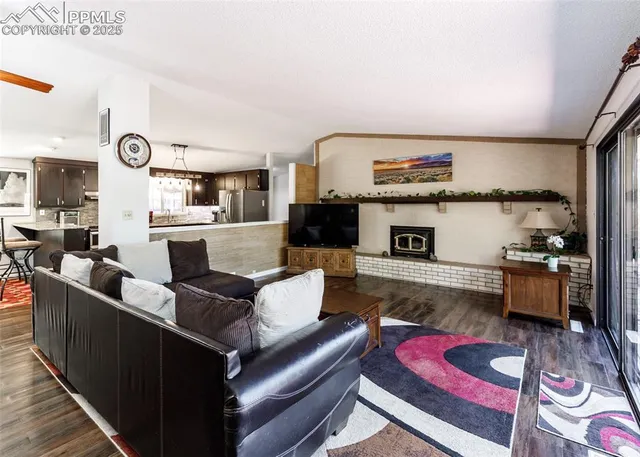 a living room with furniture fireplace and flat screen tv