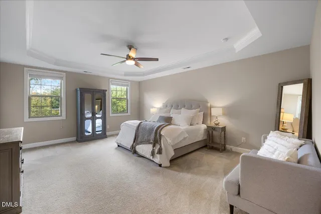 a view of a hallway with wooden floor and a bathroom
