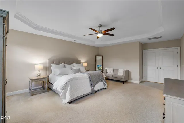 a spacious bedroom with a bed and a couch