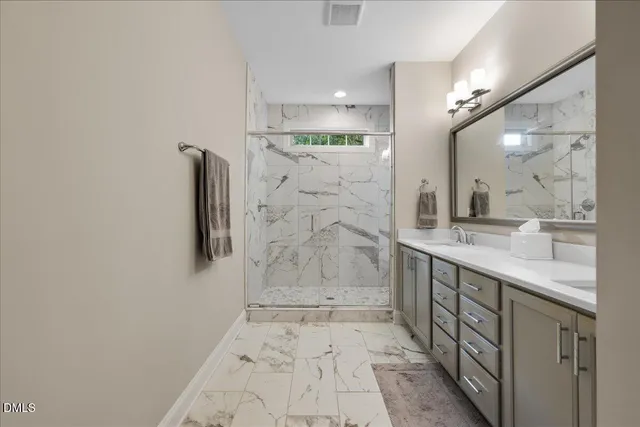 a spacious bedroom with a bed and a view of bedroom