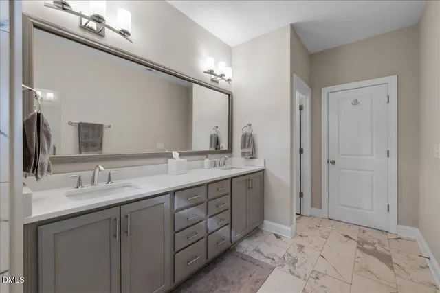 a bathroom with a shower and a sink