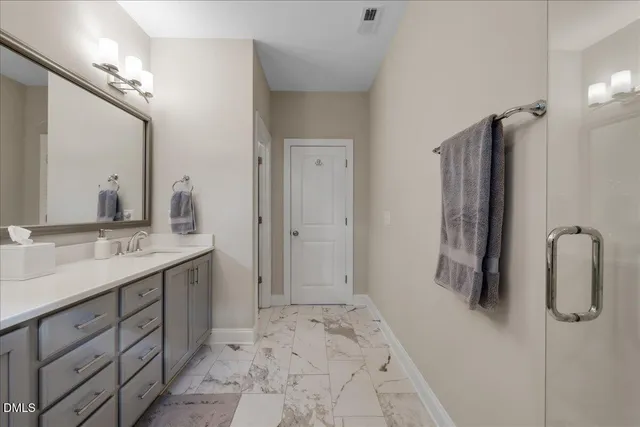 a bathroom with a double vanity sink and a mirror
