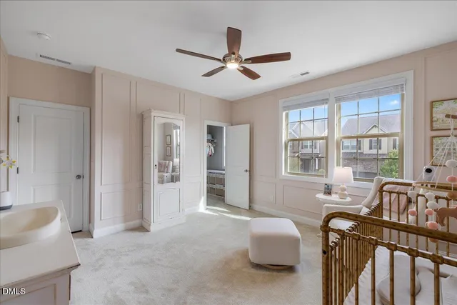 a living room with furniture and two large window