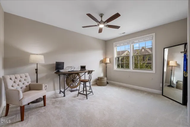 a bedroom with a bed and a ceiling fan