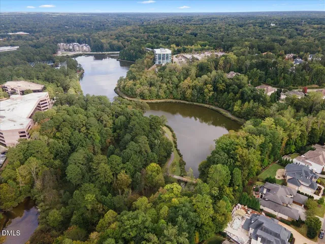 an aerial view of a city with lots of residential buildings lake and ocean view