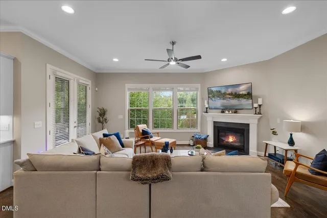 a living room with furniture a fireplace and a large window